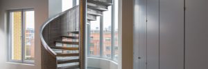 A metal spiral staircase in a refurbished building