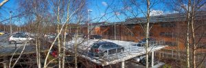 Aerial view of a dual storey car park with upper concrete decking